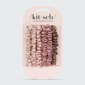 A stack of five KITSCH Ultra Petite Satin Scrunchies, in eco-friendly shades of pink and brown, is arranged from light to dark against a plain white background, offering gentle hair damage reduction.
