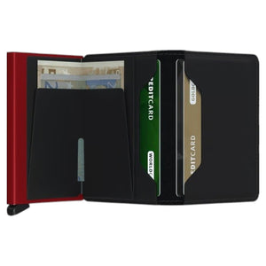 A SECRID - SLIMWALLET MATTE IN BLACK AND RED stands upright, viewed from the side, showcasing its slim profile with black textured edges and the brand name “SECRID” printed vertically in white. This RFID protected wallet blends a sleek design with advanced security, making it an ideal choice for carrying modern essentials.
