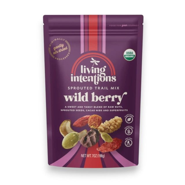 A purple bag of LIVING INTENTIONS - SPROUTED TRAIL MIX WITH MIXED BERRY, displaying images of nuts, berries, seeds, and cacao nibs. The bag features the LIVING INTENTIONS brand, is labeled USDA Organic with a net weight of 7 oz (198g), and highlights this organic sprouted trail mix as a wholesome snack choice.