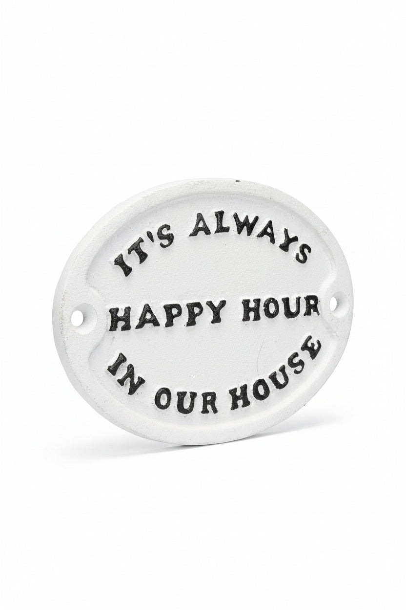 Oval white metal ITS ALWAYS HAPPY HOUR SIGN with black raised text that reads, “It’s always happy hour in our house.”.