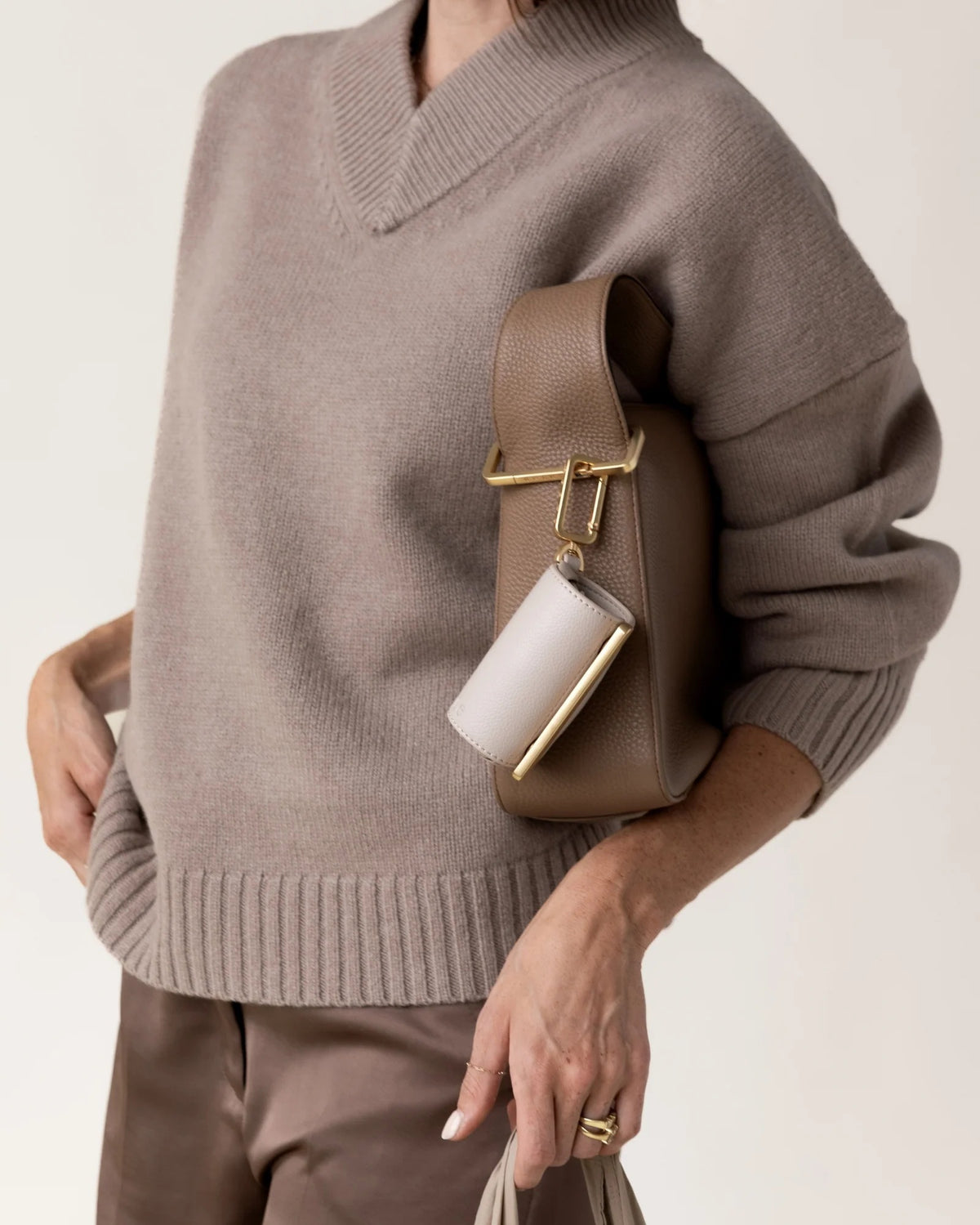The KEOTE - KEYCHAIN TOTE IN STONE by KEOTE is a beige, lightweight, crinkled tote laid flat, with a matching rectangular pouch and keychain attachment shown above for easy storage of the reusable bag.
