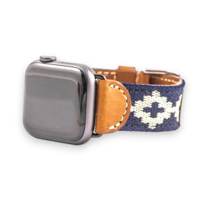 The LA MATERA CORBINA Apple Watch Band in Space Black features a rectangular screen and artisan-crafted brown leather strap with a black woven band adorned with tan diamond patterns, showcasing elegance on a crisp white background.