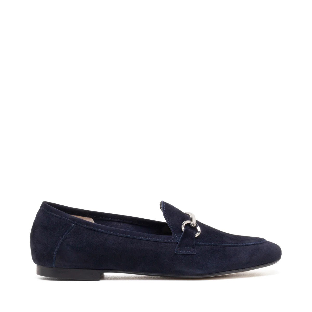 The MICHELE LOPRIORE - LEYLA LOAFER is a navy blue suede loafer adorned with a silver horsebit ornament on the vamp. Made in Italy and crafted from genuine leather, this shoe features a low heel and boasts a sleek, streamlined silhouette against a plain, off-white textured surface.