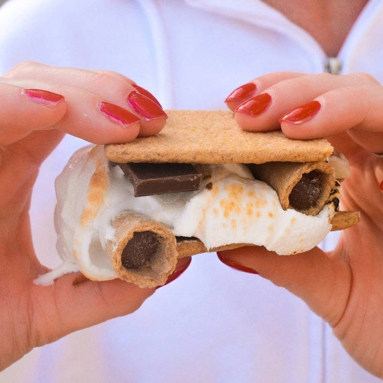 A bag of MUDDY BITES- MILK CHOCOLATE WAFFLE CONES against a brown background. The resealable packaging features the slogan "The Best Bit Over and Over Again" and boasts a 365+ day shelf life. This GMO-free product is also Kosher certified (D).
