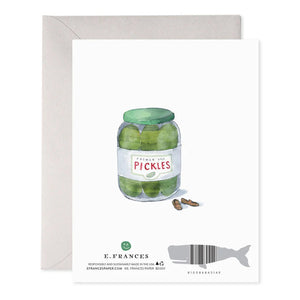 The E. FRANCES PAPER - BIG DILL GREETING CARD showcases a cartoon pickle with glasses, sitting cross-legged in an armchair, with the text: "I mean, I’m just not going to make a big dill about it. Happy Birthday." It's a charming whimsical card for any collection!.