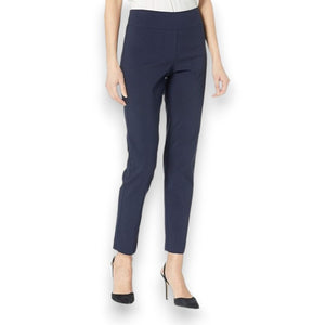 A person is wearing KRAZY LARRY, INC's PULL ON ANKLE PANT in a slim fit beige straight-leg style and black high-heeled shoes against a white background. The outfit is completed with a sleeveless black top that reveals part of the arms and torso.