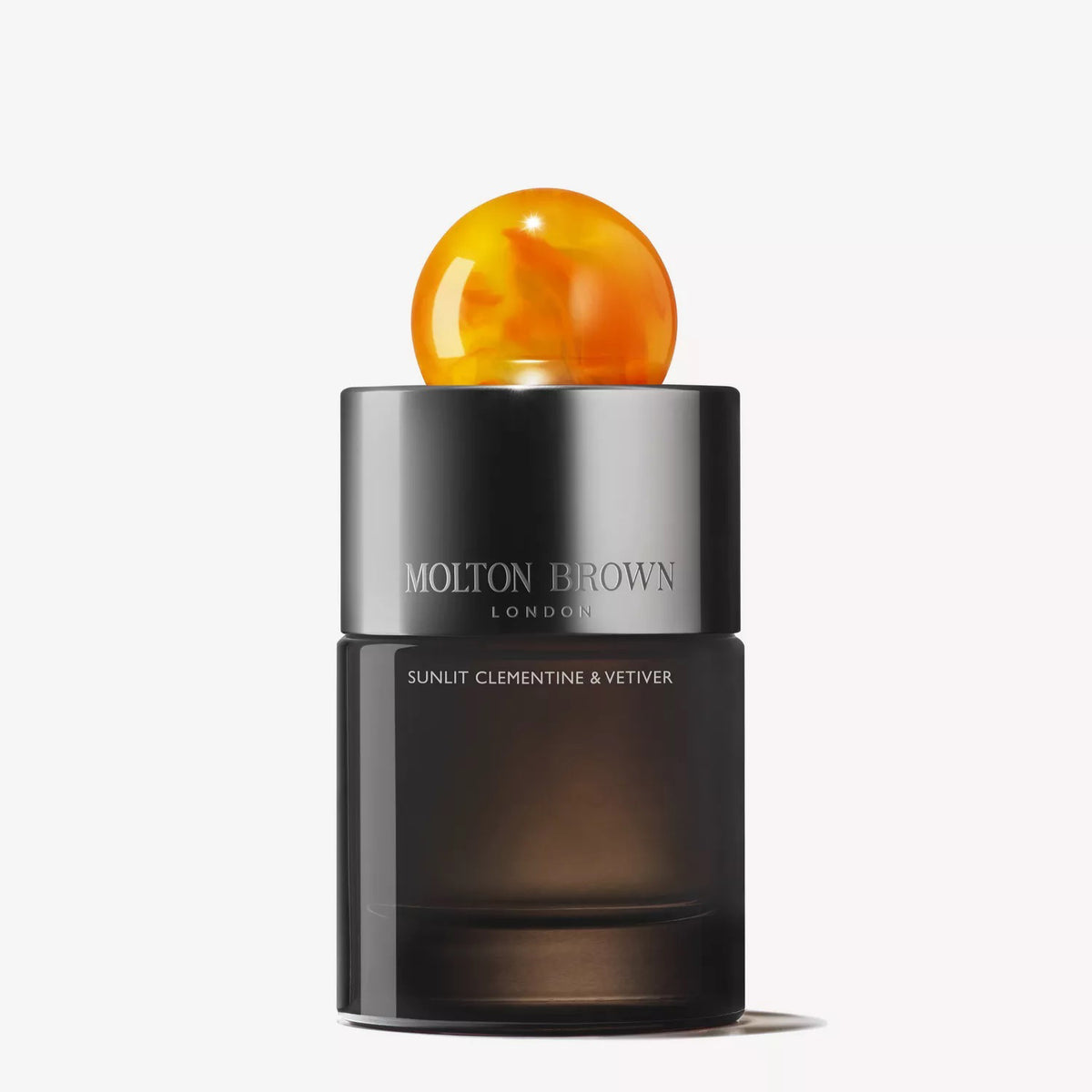 A sleek, dark MOLTON BROWN - SUNLIT CLEMENTINE &amp; VETIVER AU DE PARFUM bottle with a marbled orange cap captures the citrus essence of this Eau de Parfum against a plain white background.