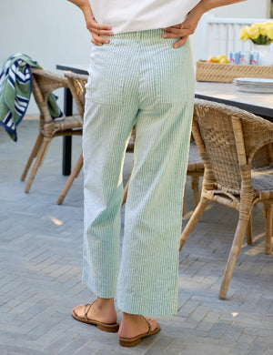 A close-up of a person wearing the FRANK & EILEEN Wexford Wide Leg Linen Pant in Lime Stripe with a white shirt partially tucked in at the waist.