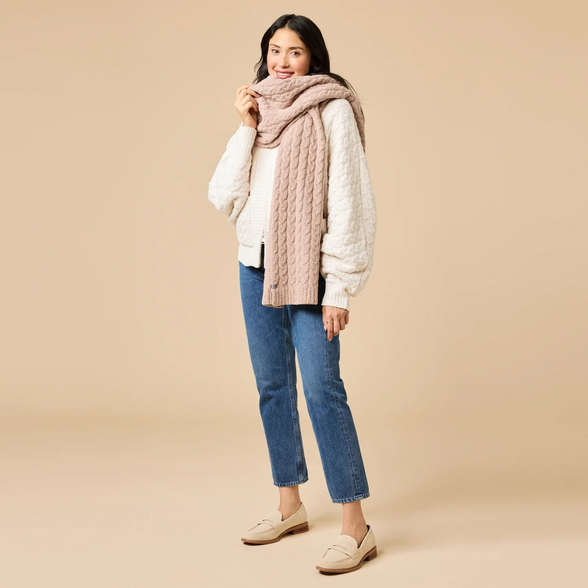 A dark navy blue SOFTIES - CABLE KNIT MARSHMALLOW SCARF draped in a loop.