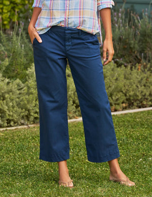 The FRANK & EILEEN Westport Italian Wide-Leg Chino in Navy is elegantly showcased against a plain white background. It features a tailored fit with side pockets and a contour waistband, neatly folded to highlight the crisp, smooth fabric, epitomizing effortless sophistication and style.