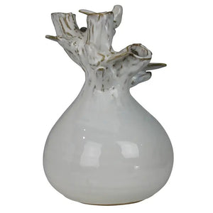 The HOMART CERAMIC VASE WITH BRANCH AND BIRD features white flowers and branches, set on a wooden surface with framed bird art and a woven basket against a light gray textured wall for a cozy touch.