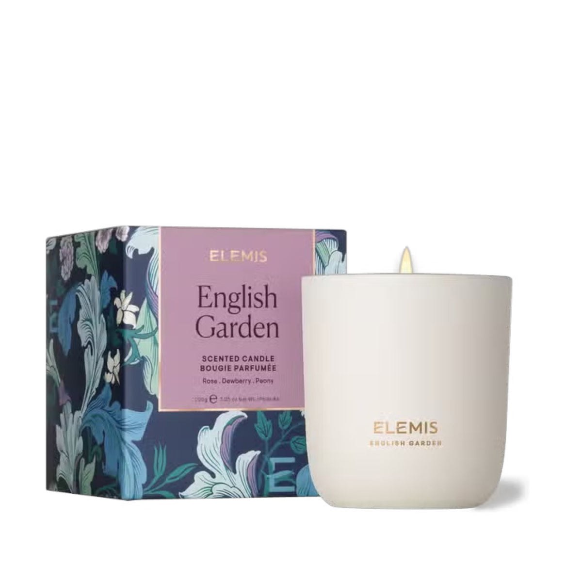 A white-scented candle, ELEMIS - ENGLISH GARDEN CANDLE, glows warmly beside its decorative box with blue, green, and white floral patterns. The elegant packaging highlights the allure of ELEMIS candles by ELEMIS - STEINER made from natural wax.