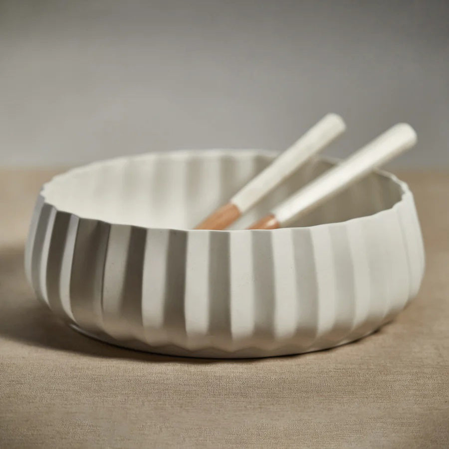 The CATALINA CERAMIC BOWL by ZODAX features a round, shallow white design with a fluted, textured exterior and smooth interior, ideal for display on a 14-inch shelf and shown on a white background.