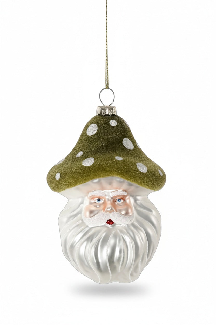ZODAX SANTA WITH MUSHROOM HAT GLASS ORNAMENT featuring Santa Claus wearing a spotted green mushroom cap, measuring 3.25 x 5 inches.