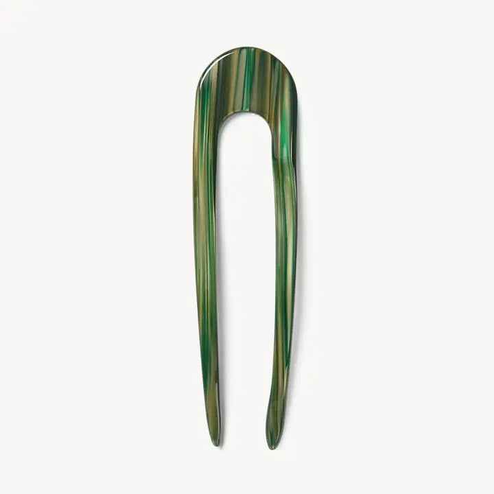 A smooth, black MACHETE - FRENCH HAIR PIN with two prongs, crafted from Italian acetate by MACHETE, rests on a plain white surface.