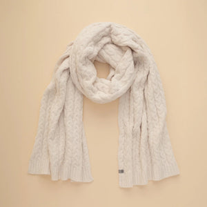 A dark navy blue SOFTIES - CABLE KNIT MARSHMALLOW SCARF draped in a loop.
