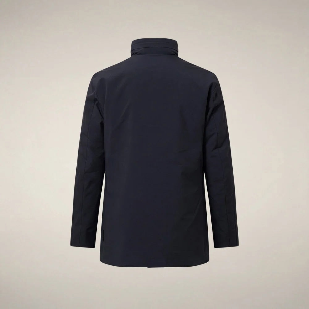 A man wears a dark blue SAVE THE DUCK - BLAISE JACKET IN BLUE BLACK with a high neck and a zippered chest pocket.