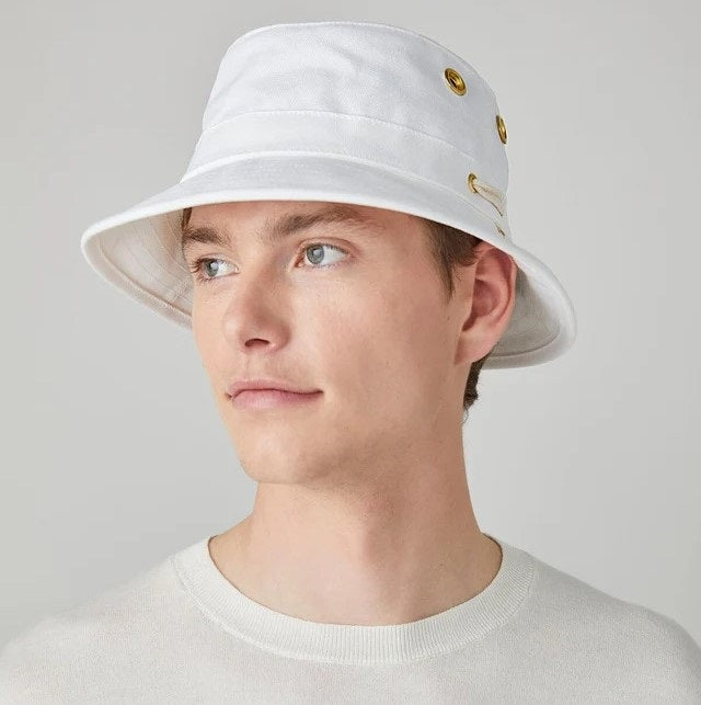 A person wearing the TILLEY - ICONIC T1 BUCKET HAT IN WHITE and a white shirt is shown from the back against a light gray background—a stylish, breathable cotton hat by TILLEY, perfect for sun protection.