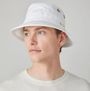 A person wearing the TILLEY - ICONIC T1 BUCKET HAT IN WHITE and a white shirt is shown from the back against a light gray background—a stylish, breathable cotton hat by TILLEY, perfect for sun protection.