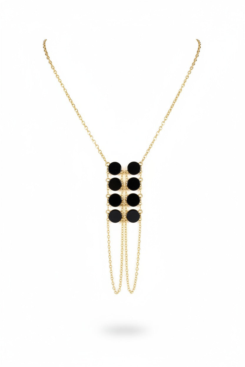The GOLDISH DOUBLE LADDERS TO BLISS BLACK ONYX CIRCLE STONE NECKLACE, featuring three vertical rows of black onyx stones, is shown on a beige fabric bust stand against a white background.