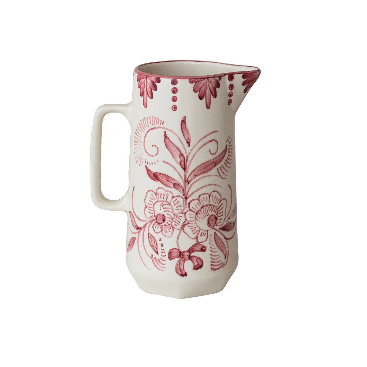 The HAND-PAINTED STONEWARE PITCHER WITH BOTANICAL DESIGN by CREATIVE COOP features a white ceramic finish, handle, and pink floral and swirl patterns with decorative dots, capturing charming cottagecore style on a plain background.