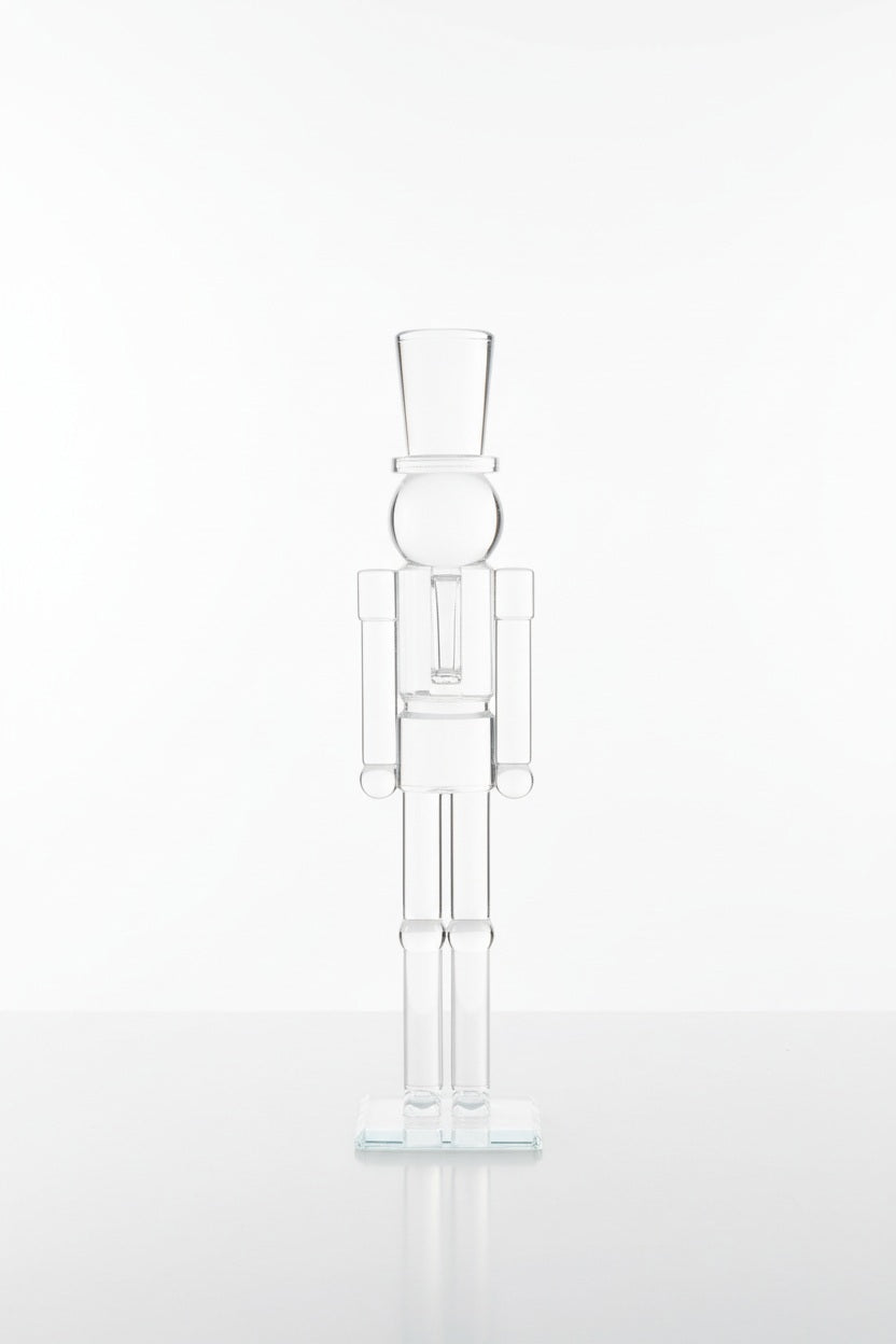 ZODAX GLASS DECOR NUTCRACKER 16″ clear glass figurine standing on a square base, resembling the elegant silhouette of a 16-inch glass vase.