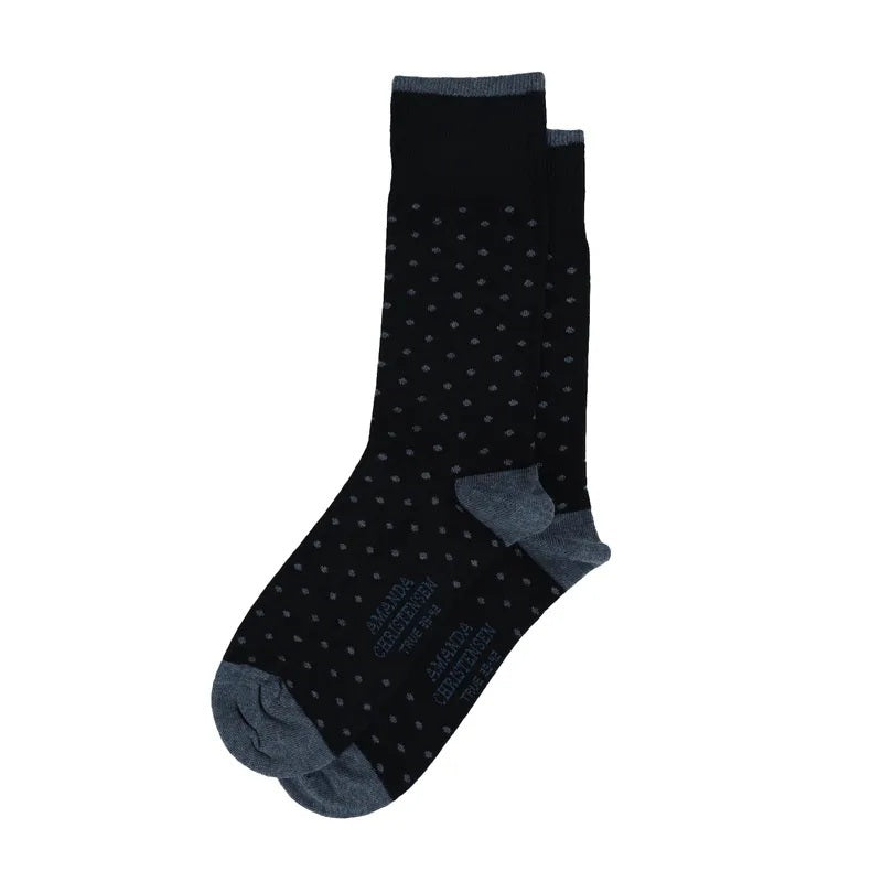 A pair of AMANDA CHRISTENSEN - TRUE DOT MID-CALF SOCKS IN DARK NAVY featuring a small repeating dot pattern with grey heels and toes.