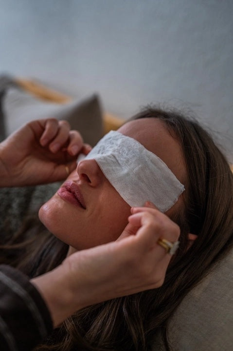 A set of MADISON GREEN - REST YOUR EYES ON THE BED relaxing eye masks and a small jar, all packaged in minimalist white with light brown text, displayed against a plain white background.