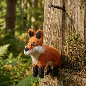 LENNOX THE FOX ORNAMENT needle-felted fox wearing wire-rimmed glasses, hanging from a twine loop.