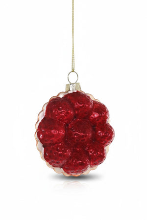 The CODY FOSTER STRAWBERRY TART ORNAMENT, featuring glossy red berries and a gold string, is a charming collectible or a unique gift for design lovers.