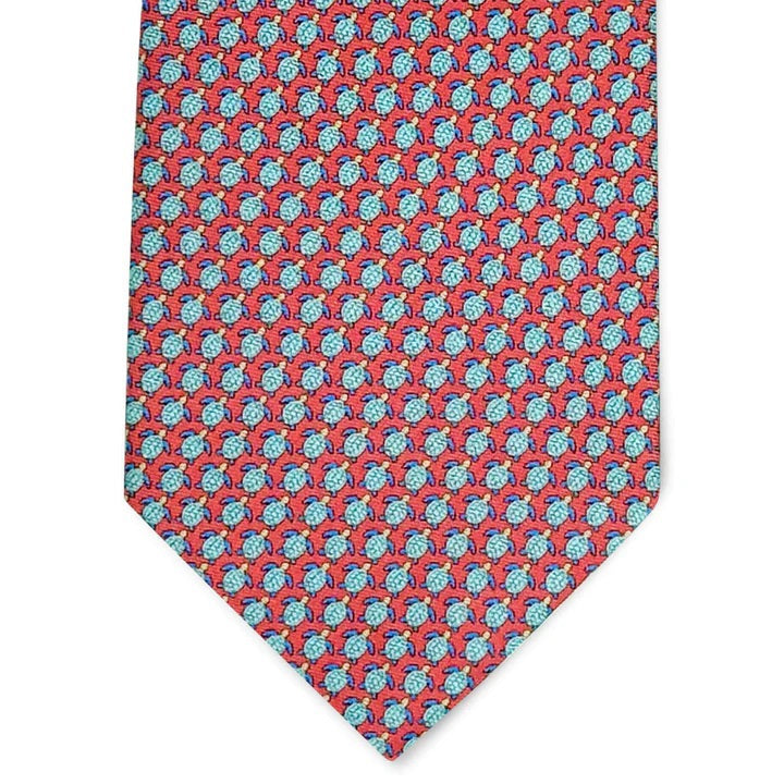The BIRD DOG BAY PETER-BLAIR Tortuga Silk Tie in Pink features a pink background with a repeating pattern of small blue and red turtles.