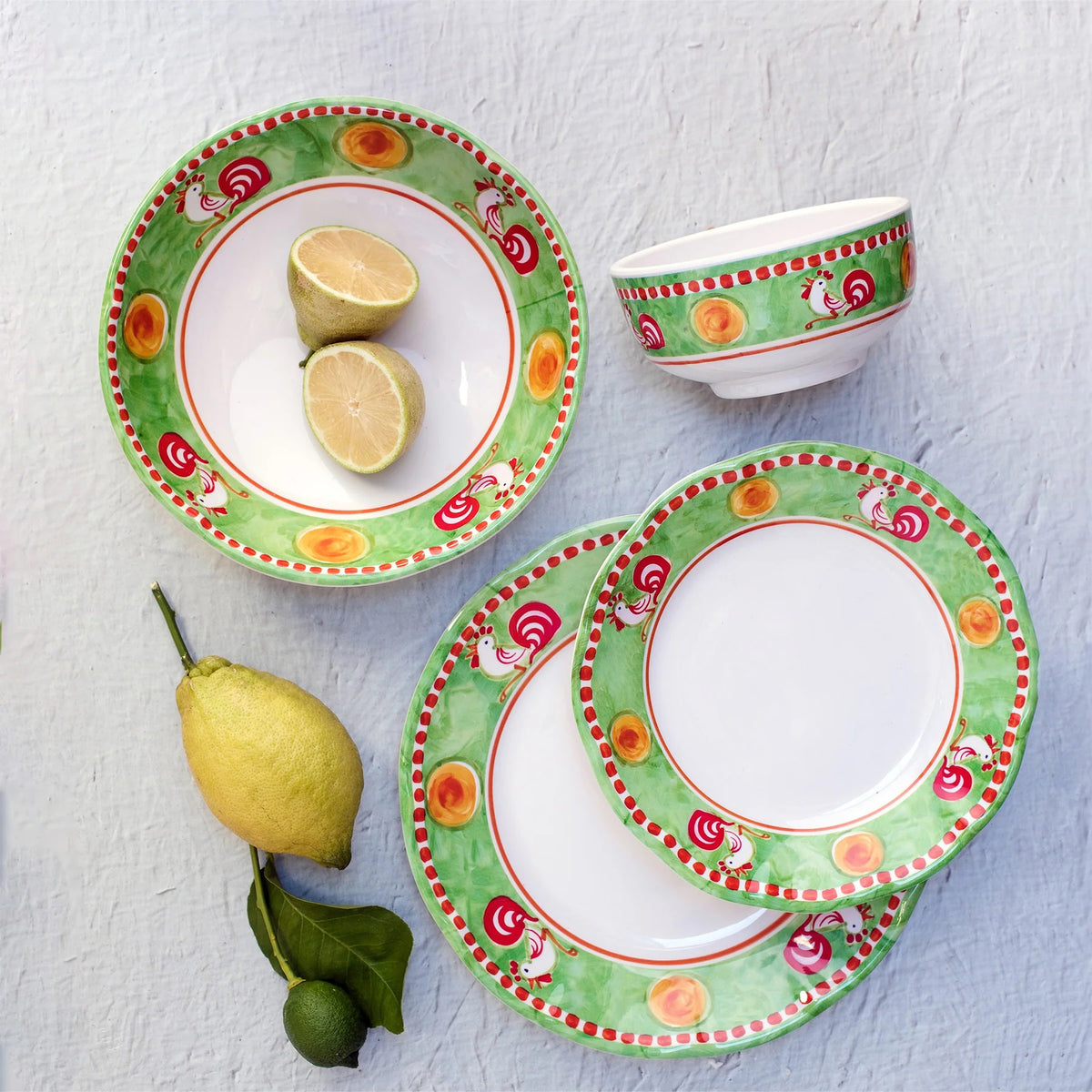 The VIETRI Melamine Campagna Pasta Bowl features a red interior with playful pig and fruit designs, a blue patterned edge, and a durable white melamine build—perfect for outdoor dining.