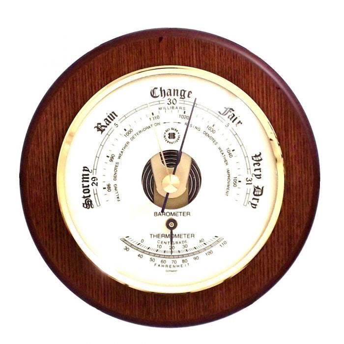 The BEYBERK INTERNATIONAL BAROMETER WITH THERMOMETER is a round, vintage-style cherry wood piece featuring a cream dial with black needle, weather markings (“Stormy” to “Very Dry”), and an integrated thermometer at the bottom.