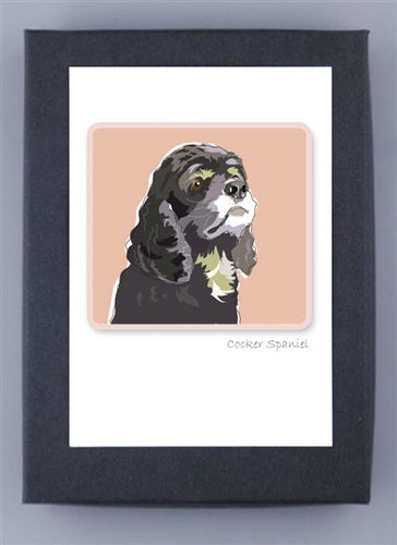 The PAPER RUSSELLS Cocker Spaniel Box Notes features a dark-furred, white-highlighted Cocker Spaniel illustration on a peach backdrop. It's centered on a white card with a black border and printed on recycled paper, with "Cocker Spaniel" below the image.