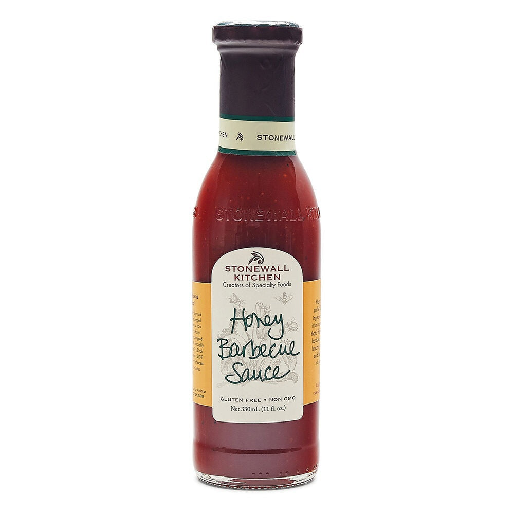 A bottle of STONEWALL KITCHEN- HONEY BARBECUE SAUCE from Stonewall Kitchen, featuring a green cap and tan label with details about its honey barbecue flavor and gluten free, non-GMO ingredients—ideal as a tasty barbecue glaze for grilled meats.