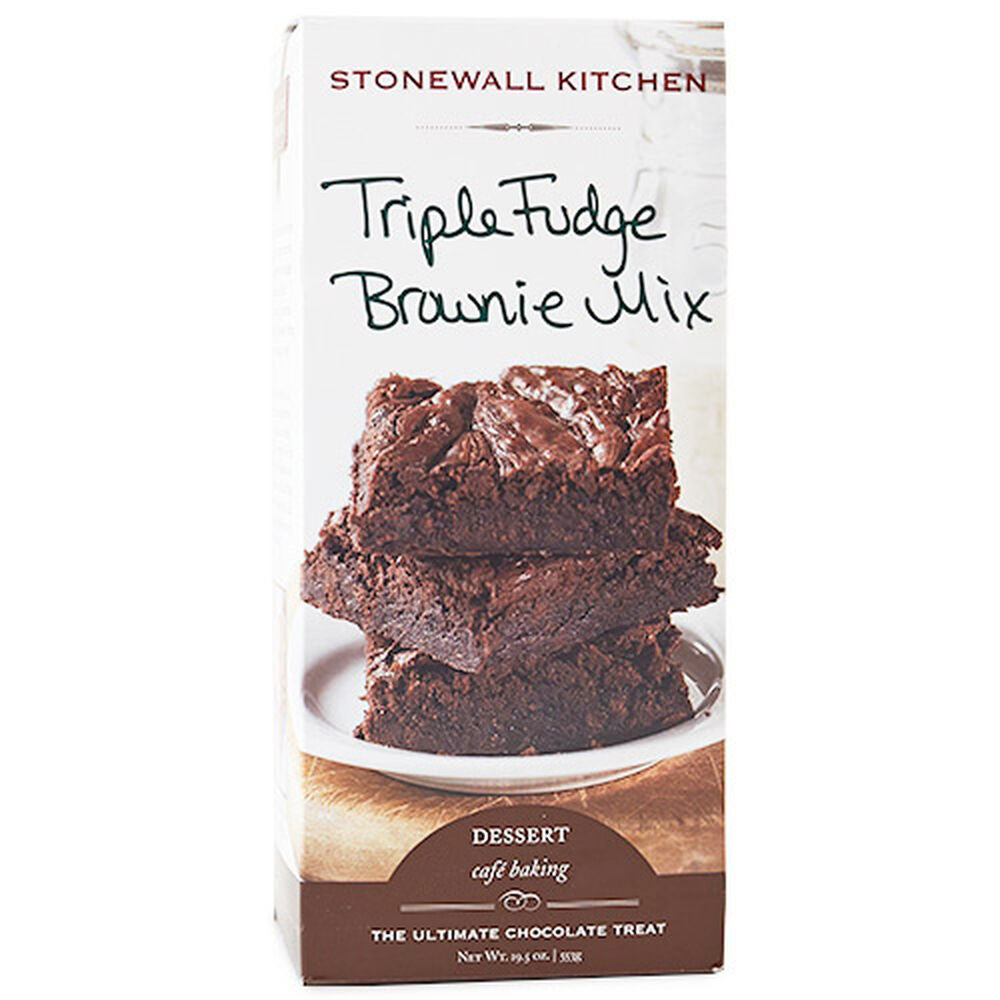 A box of STONEWALL KITCHEN - TRIPLE FUDGE BROWNIE MIX is pictured. The front of the box showcases an image of three stacked chocolate brownies on a white plate. The product name, &quot;Triple Fudge Brownie Mix,&quot; is artistically written in a casual handwritten style, perfectly capturing these easy-to-make brownies.
