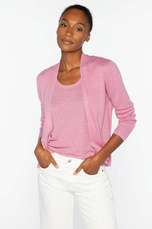 A person with dark hair in a bun is shown from the back, modeling the KINROSS CASHMERE - OPEN RIB LINEN CARDIGAN by KINROSS in pink with white pants against a plain white background.