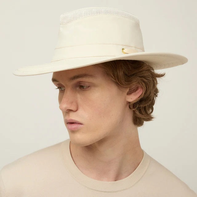 The TILLEY AIRFLO BROAD BRIM HAT LTM6 in Light Stone is a recycled nylon sun hat with UPF 50+ protection, wide brim, mesh ventilation near the crown, and a small band tag. Shown on a plain white background.
