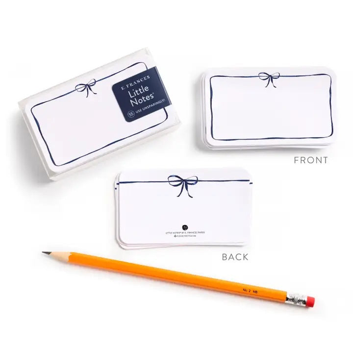 E. FRANCES PAPER’s LITTLE NOTES NAVY BOW is a rectangular white mini note card with a thin hand-drawn navy border and a small bow at the top—blank inside, ideal for any boxed set of Little Notes.