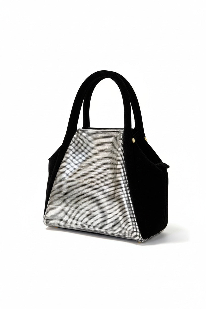 The OLIVEVE Mini Taya Top Handle, crafted from Italian leather in black, boasts a sleek modern design with a metallic front panel reflecting distorted images. This elegant handbag features two handles and stands out against its plain white backdrop.