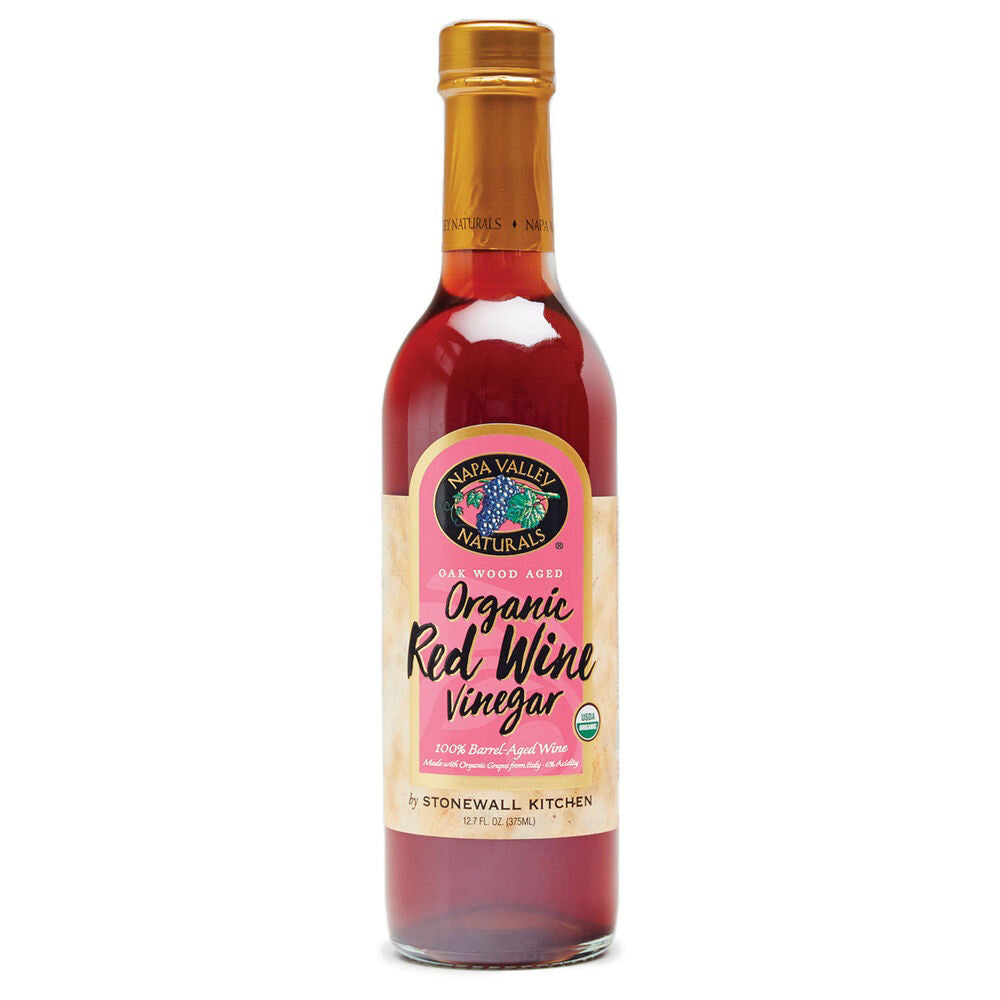 A bottle of Stonewall Kitchen Organic Red Wine Vinegar is shown. This Italian red wine vinegar is oak wood aged and contains 12 fl oz (375 ml). The bottle features a golden cap and a red and cream label with Stonewall Kitchen branding.