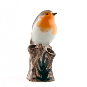 The QUAIL CERAMICS - ROBIN BUD VASE by QUAIL DESIGNS is a handpainted stoneware vase featuring a ceramic robin with an orange breast perched on a leafy tree stump on a white background.