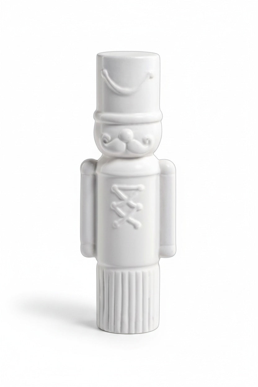 ZODAX DECORATIVE CERAMIC SOLDIER - MEDIUM white ceramic nutcracker figure measuring 3.5 inches by 9.5 inches, featuring a cylindrical hat, mustache, and button detail.