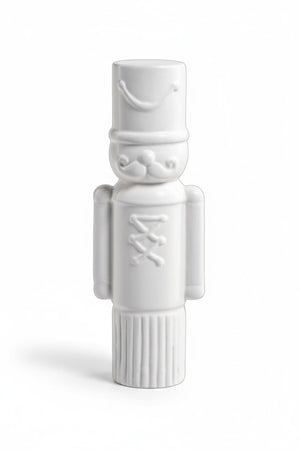 ZODAX DECORATIVE CERAMIC SOLDIER - MEDIUM white ceramic nutcracker figure measuring 3.5 inches by 9.5 inches, featuring a cylindrical hat, mustache, and button detail.