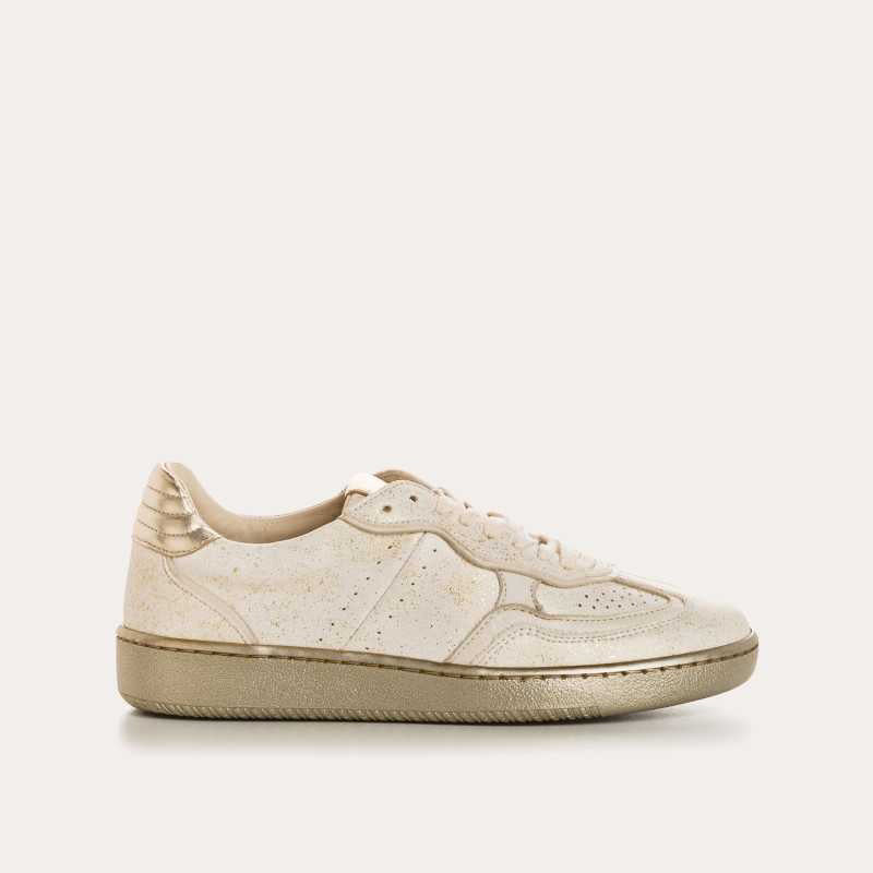 The REQINS ATHENA GLAM sneaker in platinum off white features suede leather, a textured sole, and stitched details, displayed from the side against a plain light background.