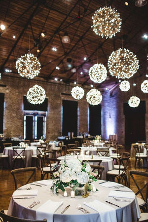 The PRE-LIT GRAPEVINE BALL - 12 INCHES by EGRAPEVINESTORE features intertwined brown branches with small warm white LED lights, creating a dense and textured appearance while adding a festive and cozy glow.