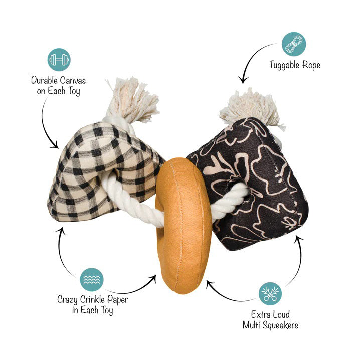 Introducing the PET SHOP BY FRINGE STUDIO - ROPED IN CANVAS DOG TOY: This interactive toy features a sturdy white rope threaded through three engaging shapes—a black-and-white checkered triangle, a yellow donut-shaped ring, and a square adorned with black and white floral designs. Made from durable cotton canvas for lasting play, the securely knotted rope ends ensure added safety.