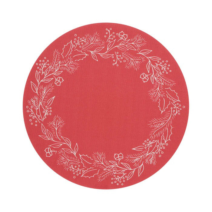 The CHILEWICH - WREATH PRINT PLACEMAT is a round, red placemat featuring a white botanical wreath with leaves, berries, and pine branches around the edge. Its center is plain red for a festive, elegant look.