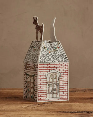 HOME FOR THE HOLIDAYS TISSUE BOX COVER shaped like a house, featuring an embroidered Christmas tree, string lights, and a teddy bear in a Santa hat for festive holiday home decor.
