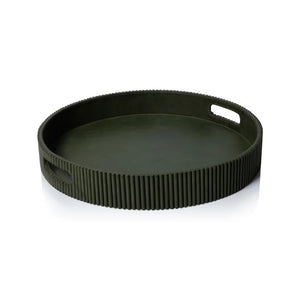 Close-up of the ZODAX ROUND FLUTED LEATHER TRAY IN GREEN, showcasing a smooth top and vertical, evenly spaced ridges on the sides for a modern, textured look.